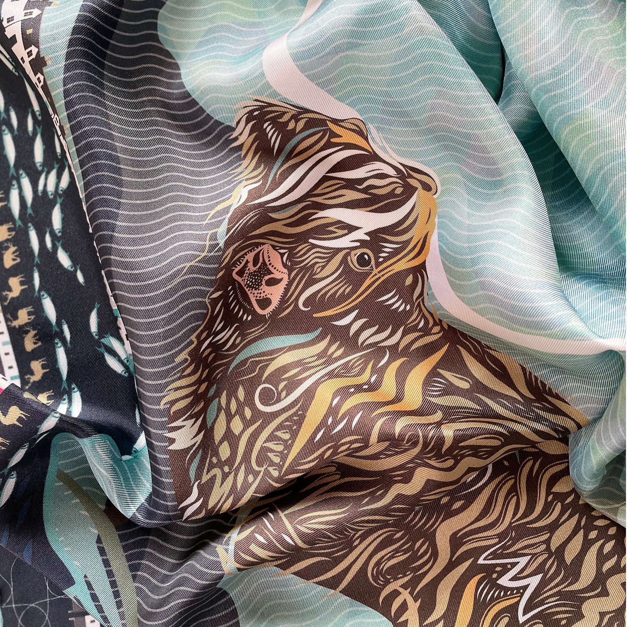 A Highland coo detail on our Bealach na Bà scarf design inspired by and created in the Scottish Highlands and perfect for a special present.